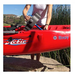 Bixpy Hobie Mirage Pedal Adapter being put into place into a red Hobie kayak.  Side view of the easy installation of the Hobie Mirage Pedal Adapter