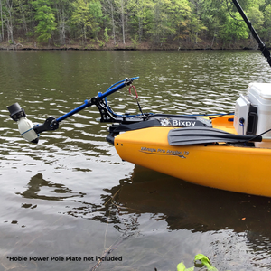 Hobie Pro Angler Compass Outback Power Pole Adapter slightly unhinged but out of the water while attached to the yellow kayak connecting it to the kayak motor. Only the back portion of the kayak is visible.