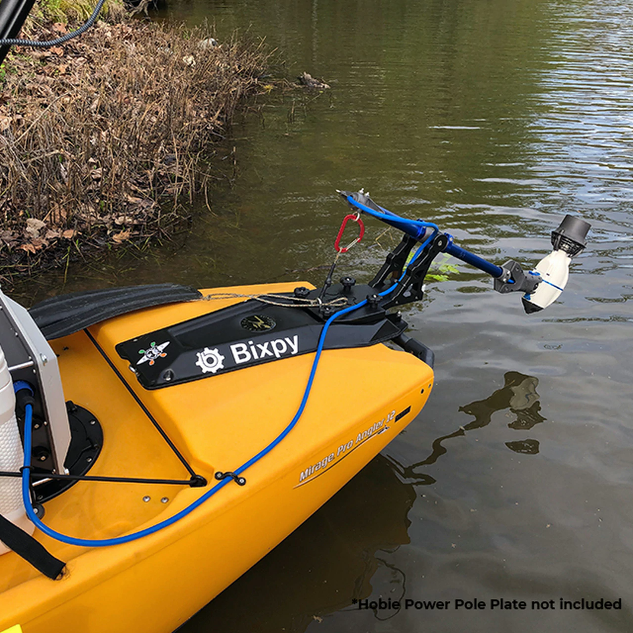 Hobie Pro Angler Compass Outback Power Pole Adapter slightly unhinged but out of the water while attached to the yellow kayak connecting it to the kayak motor. Only the back portion of the kayak is visible.