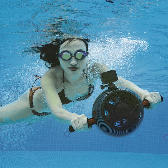 Yamaha Jet Pod Pro Sea Scooter is used in a pool by a beautiful woman in a bikini. We see a front view of the Jet Pod Pro Seascooter and the GoPro camera on top.