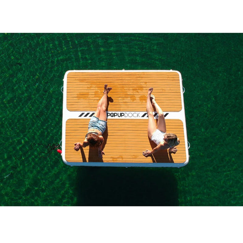 POPUP Inflatable Dock on the water with two adults relaxing on it.