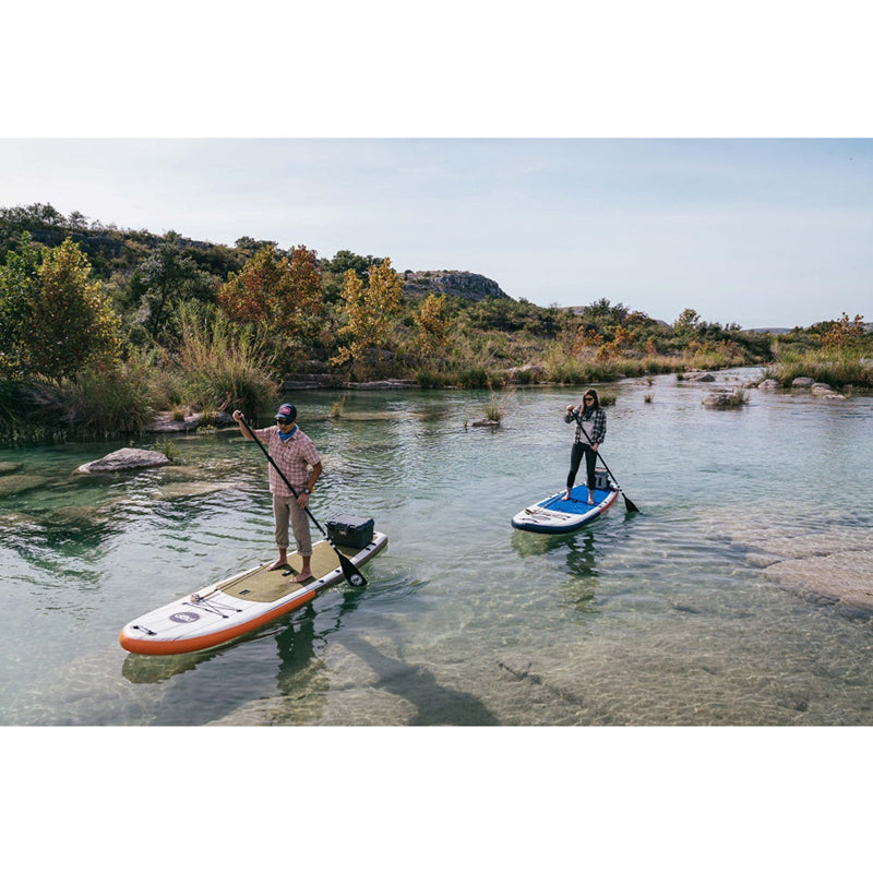 El Capitan 11'6" Inflatable SUP beside the water with 2 people paddleboarding.