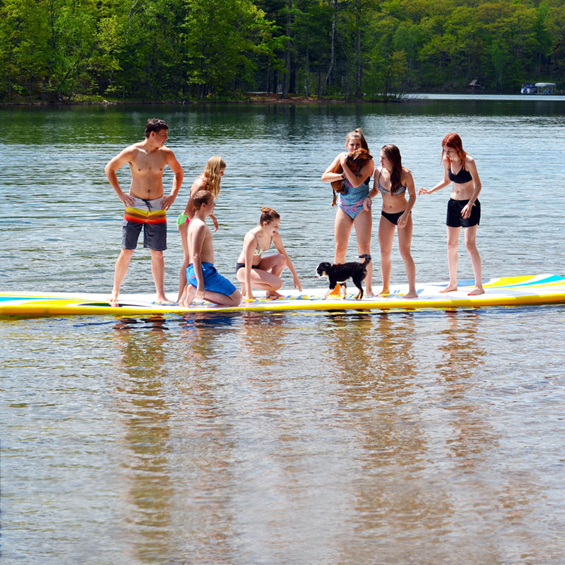 Aqua Mat Deluxe 20' on the water with 7 people on it plus 2 dogs.